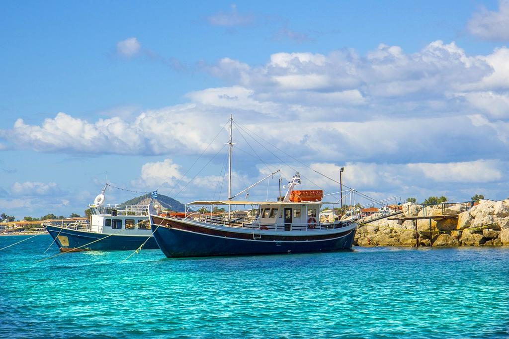 Friendly travel expert assisting a solo traveler at a desk