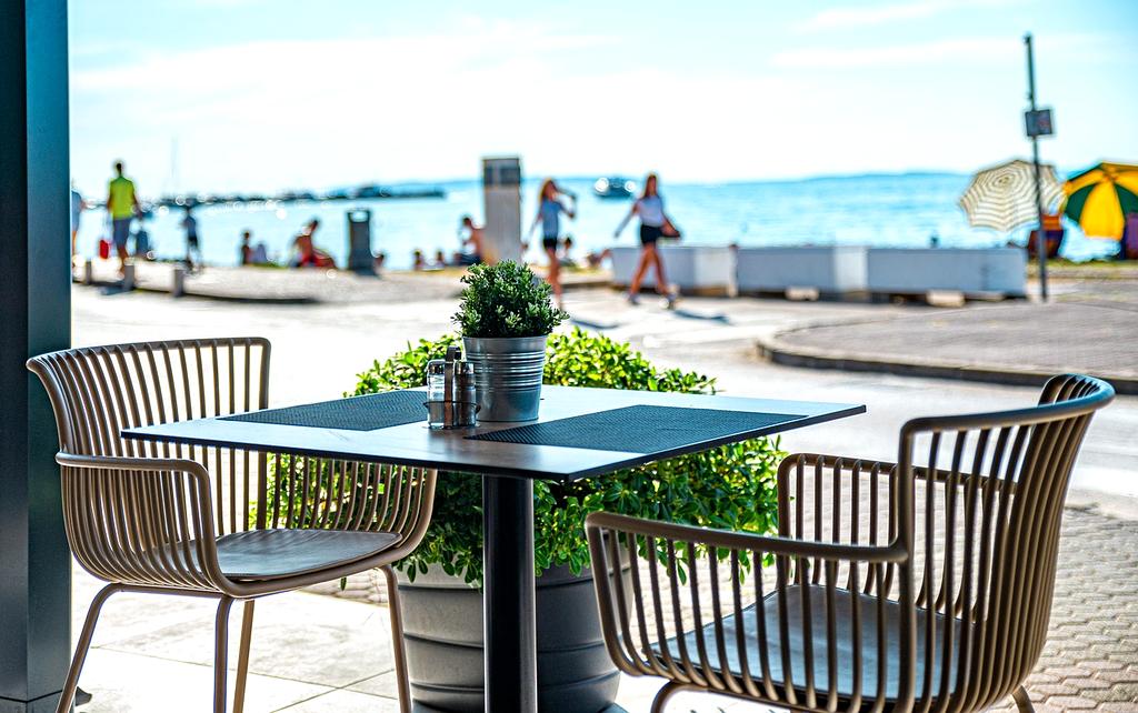 Travel itinerary document on table with pen and glasses